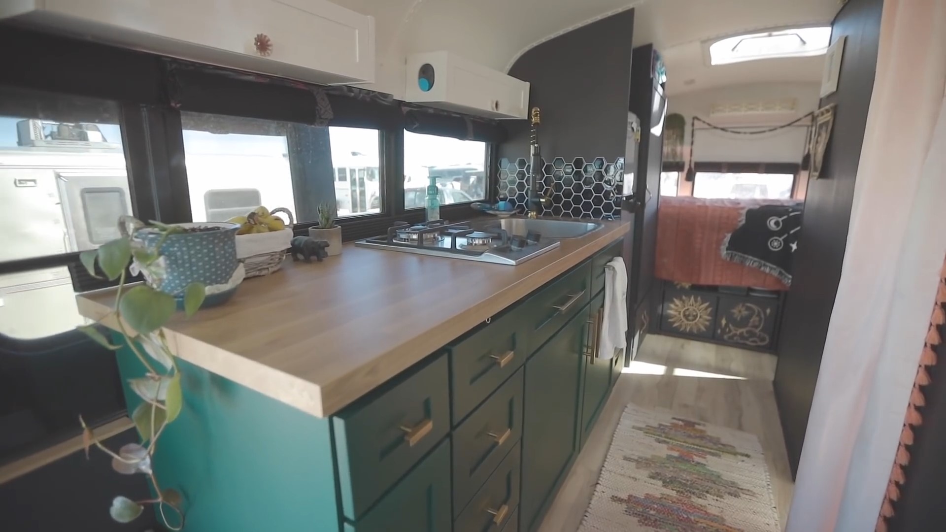 Small kitchen with green cabinets and gold hardware