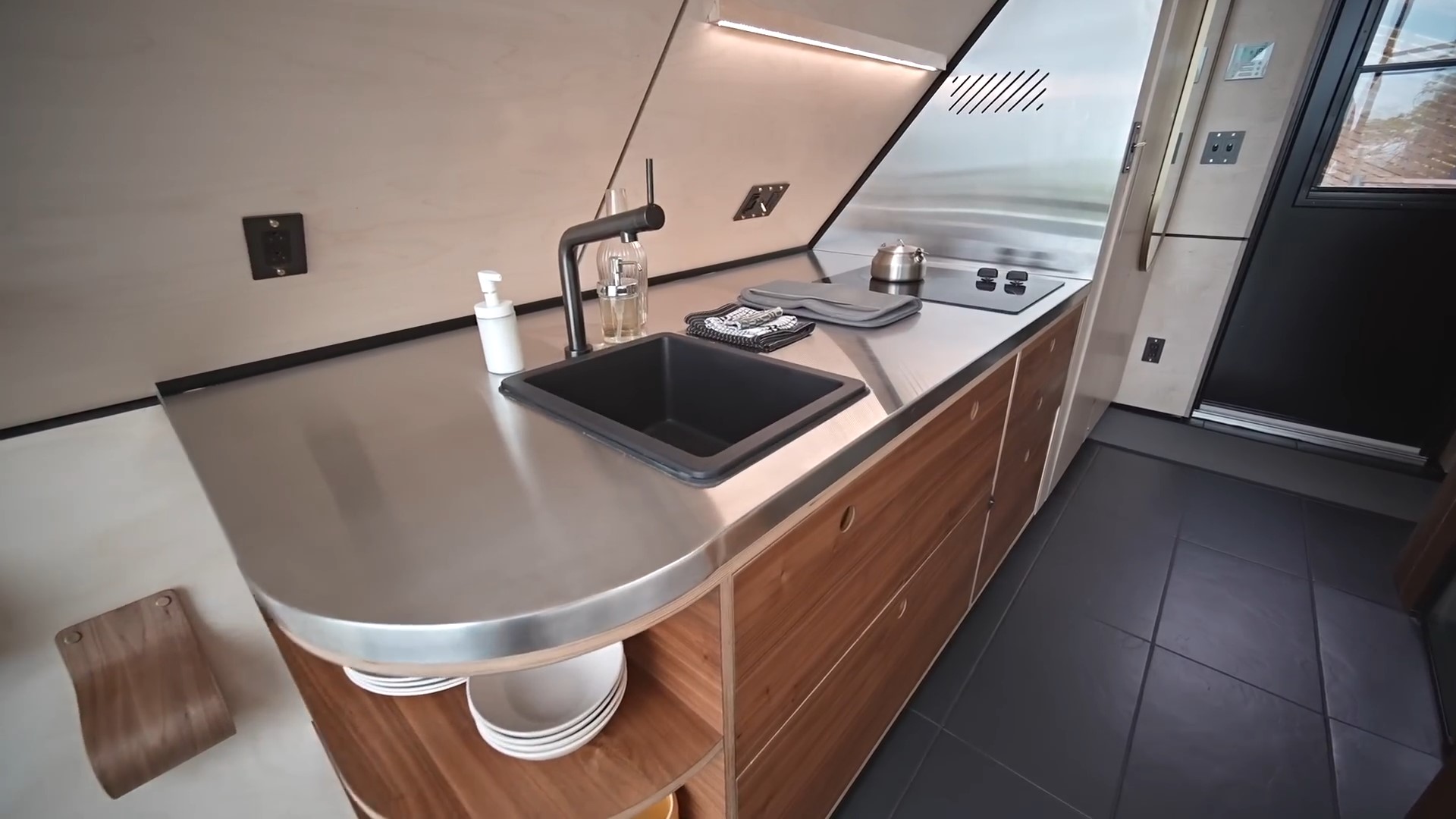 modern kitchen with wooden cabinets and black sink