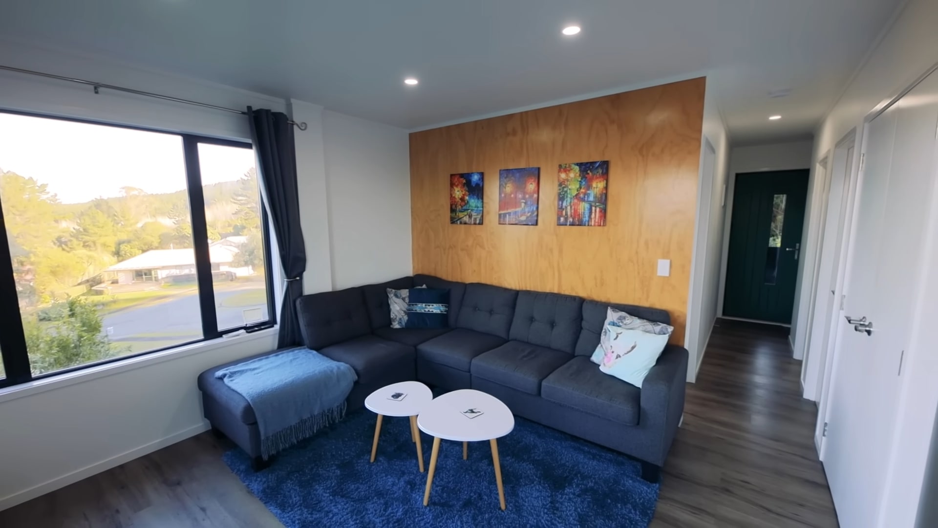 Living room with couch and wooden backsplash