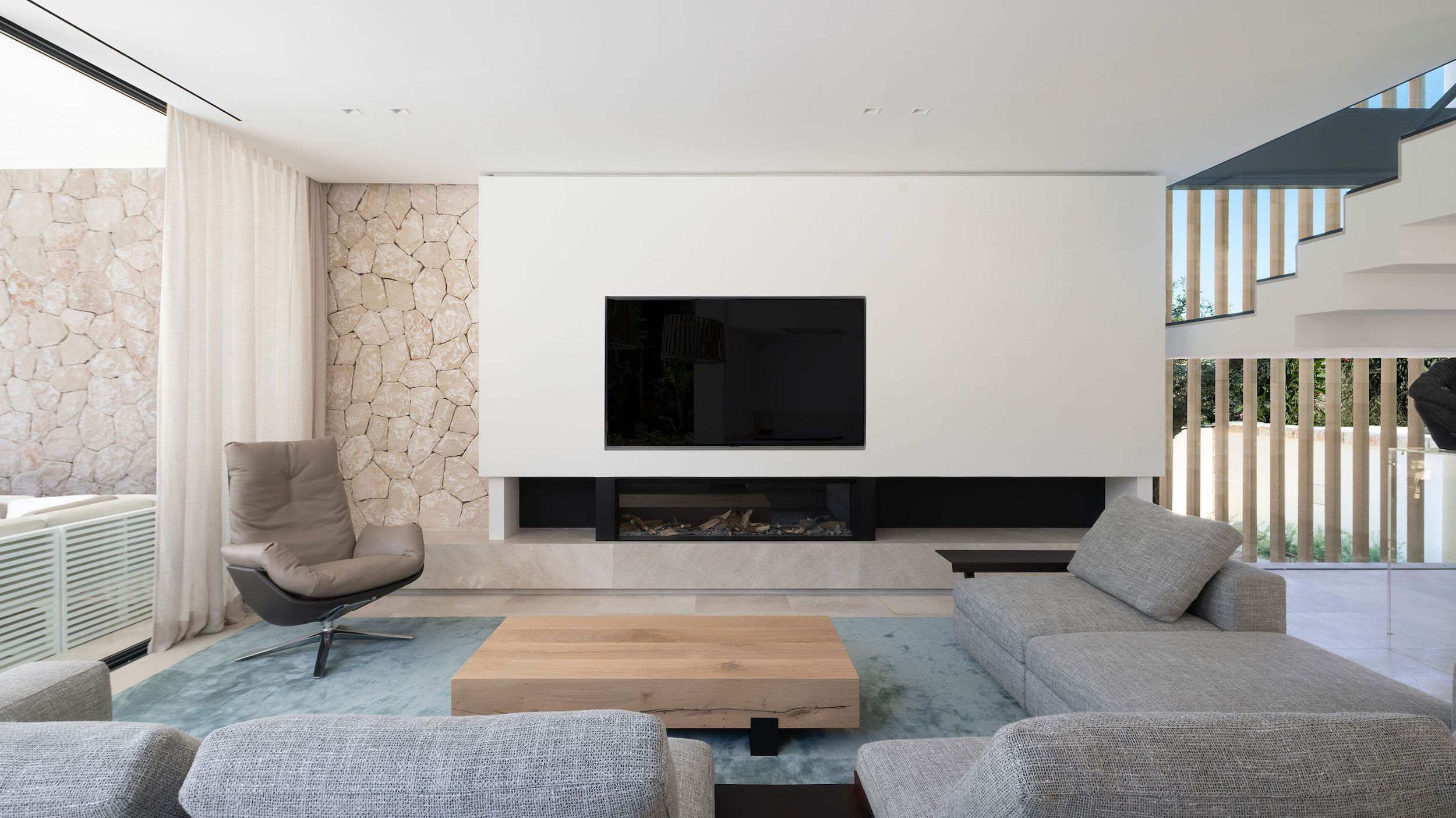 large living room with TV and modern fireplace