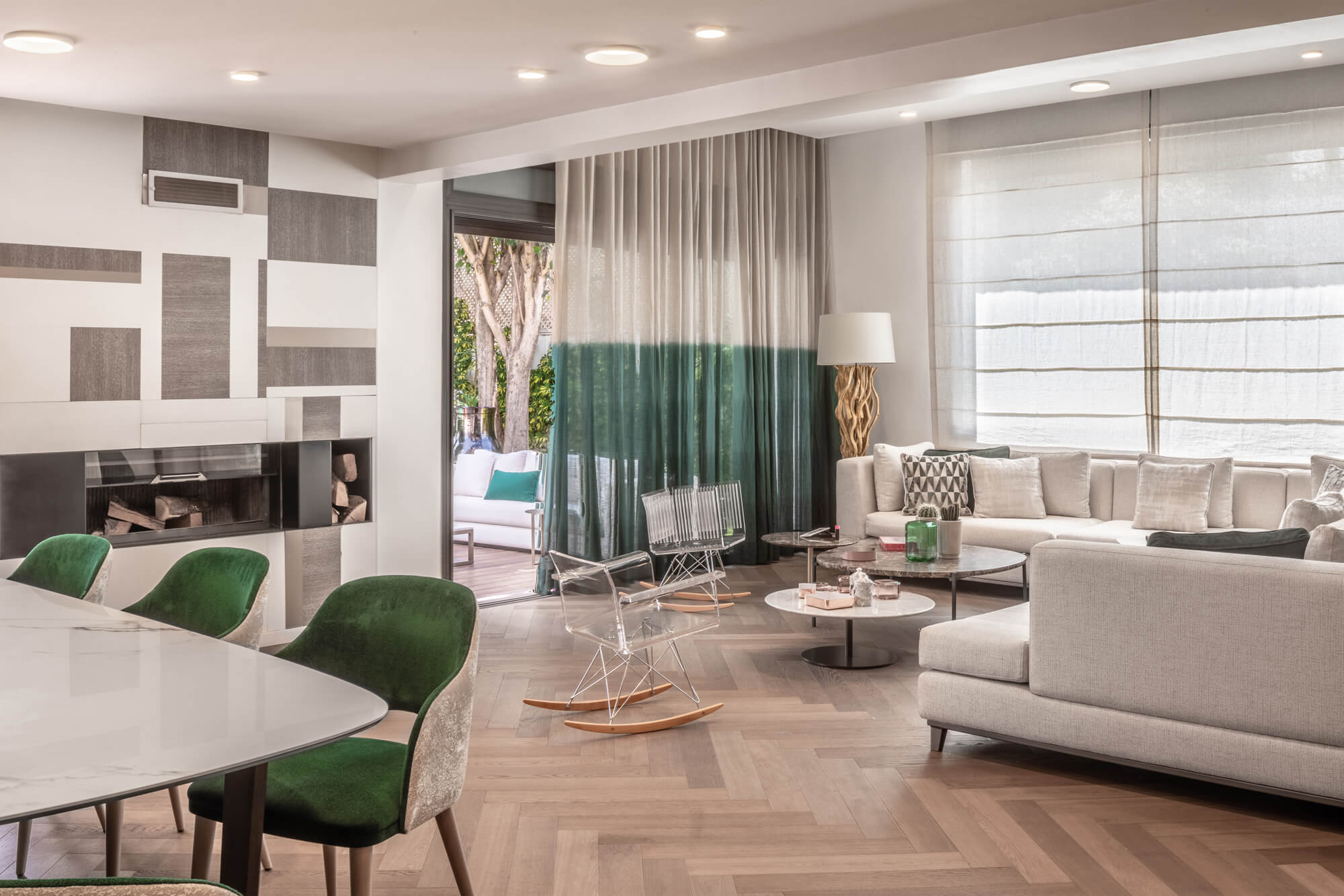 living room with a beige couch, rocking chairs and beige and green curtains