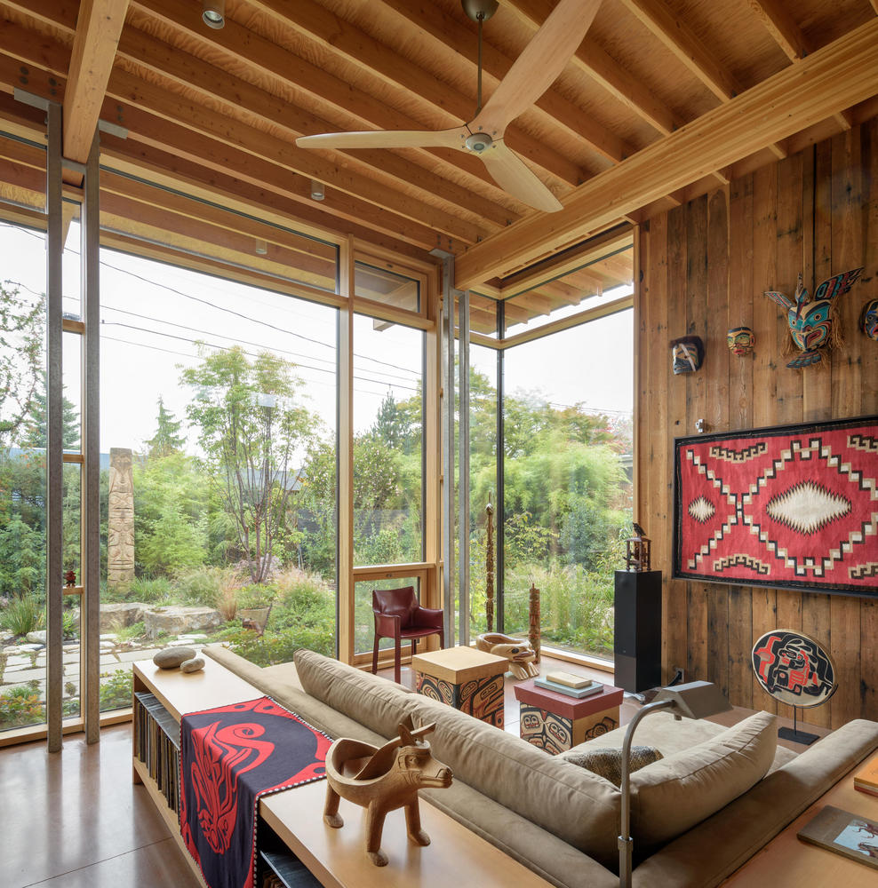 living room with a beige couch and floor to ceiling windows