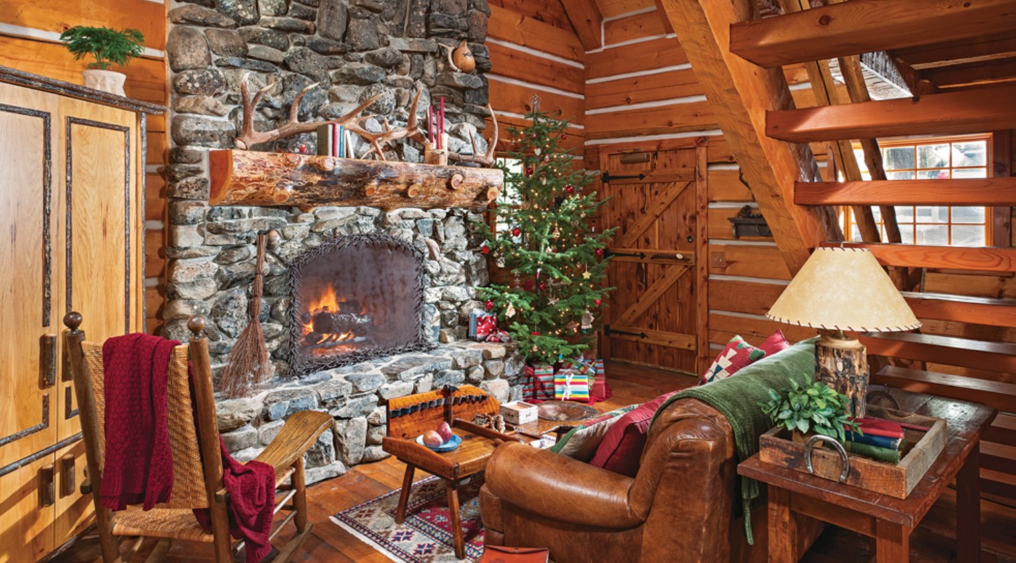 Living room with stone fireplace, leather couch, and wooden interior