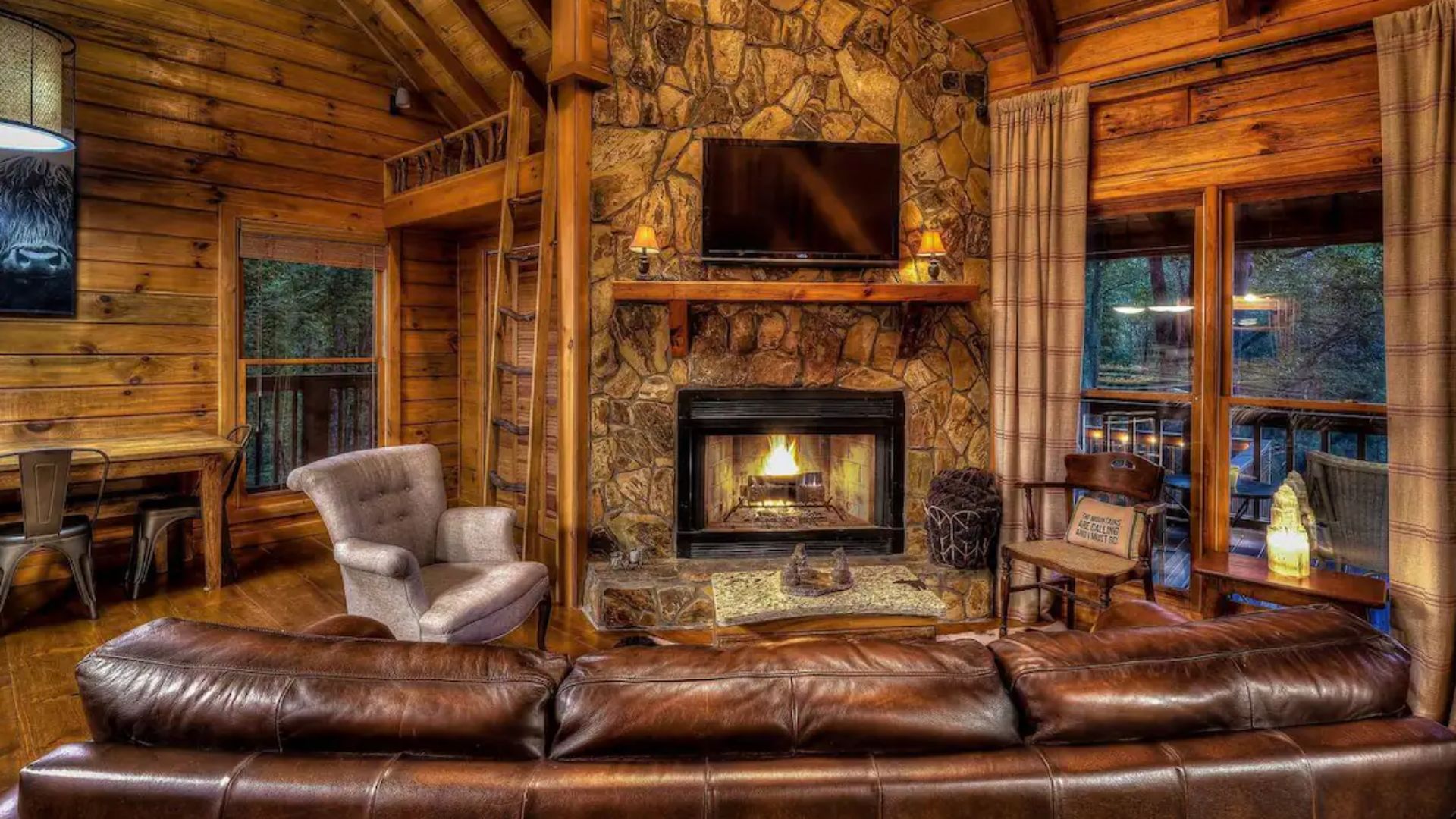 stone fireplace and leather couch sitting area