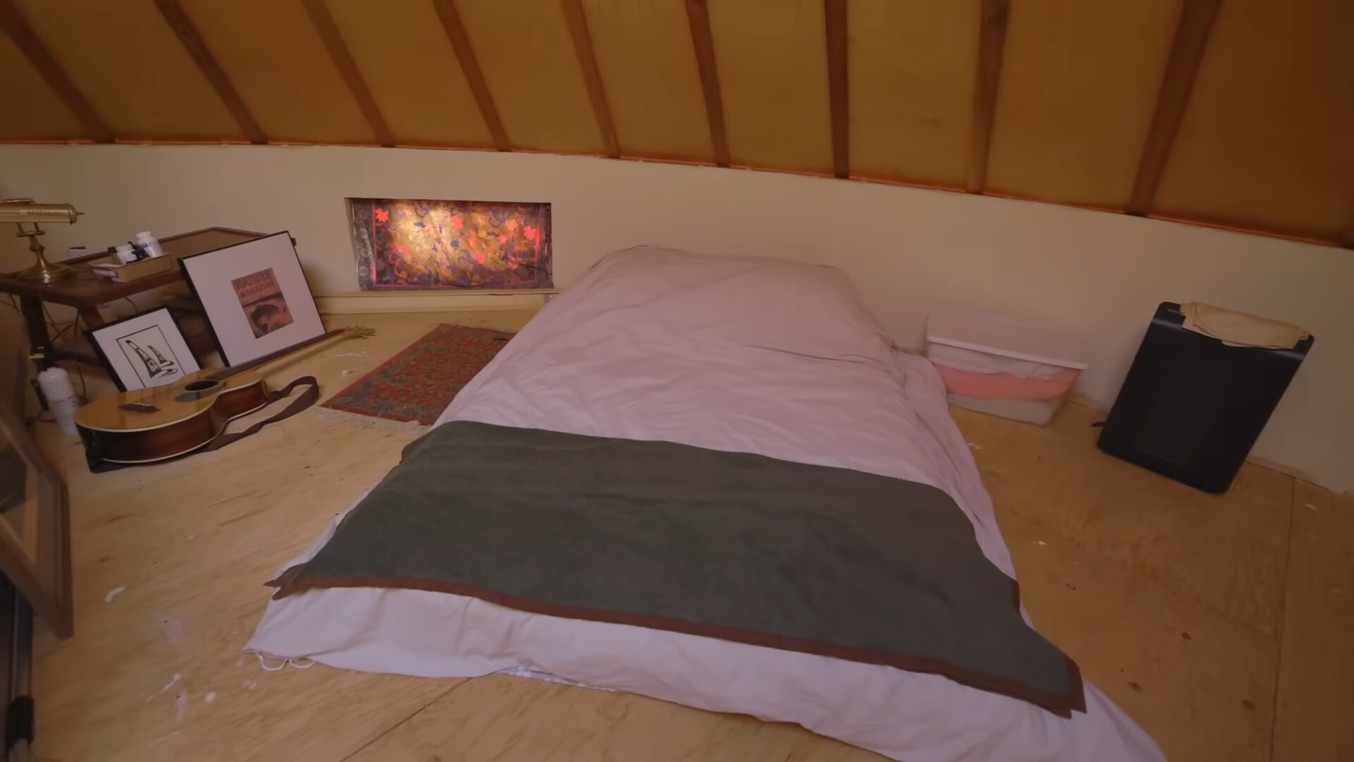 loft area in a cabin with a bed in the middle