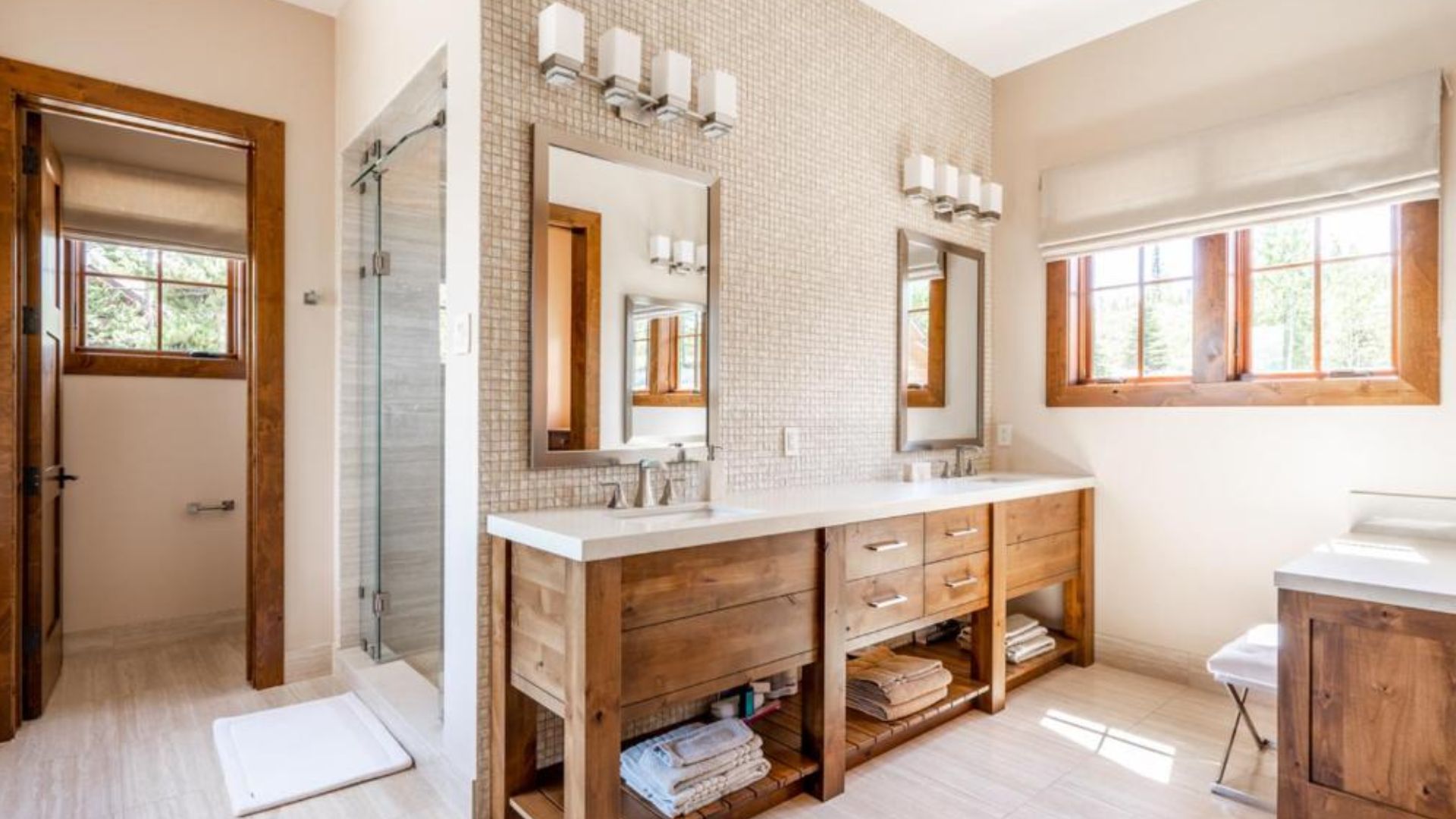 master bathroom with wooden cabinets and a double vanity with wooden accents