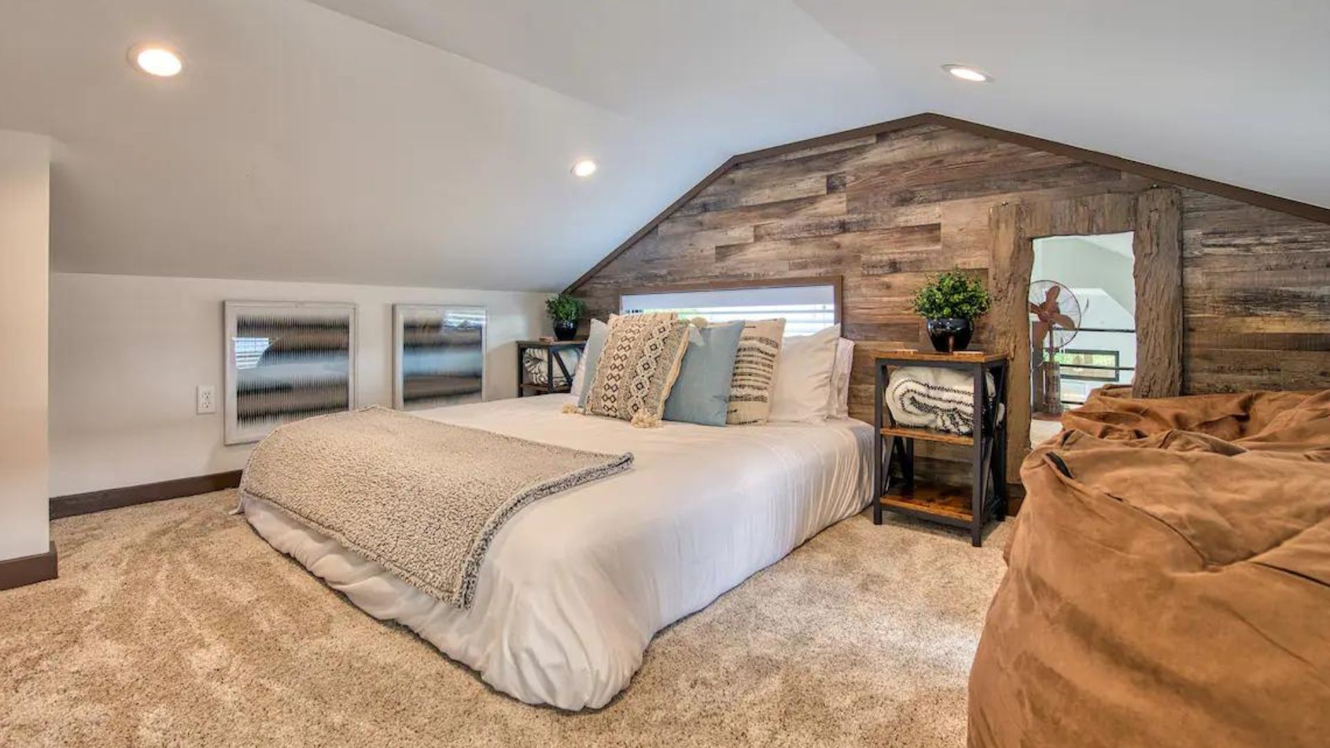 master bedroom in loft area, floor bed looking comfortable, and a fuzzy carpet in beige