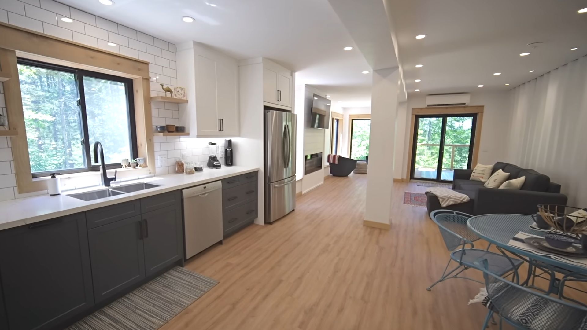 open concept kitchen with living room and dining room in a container home