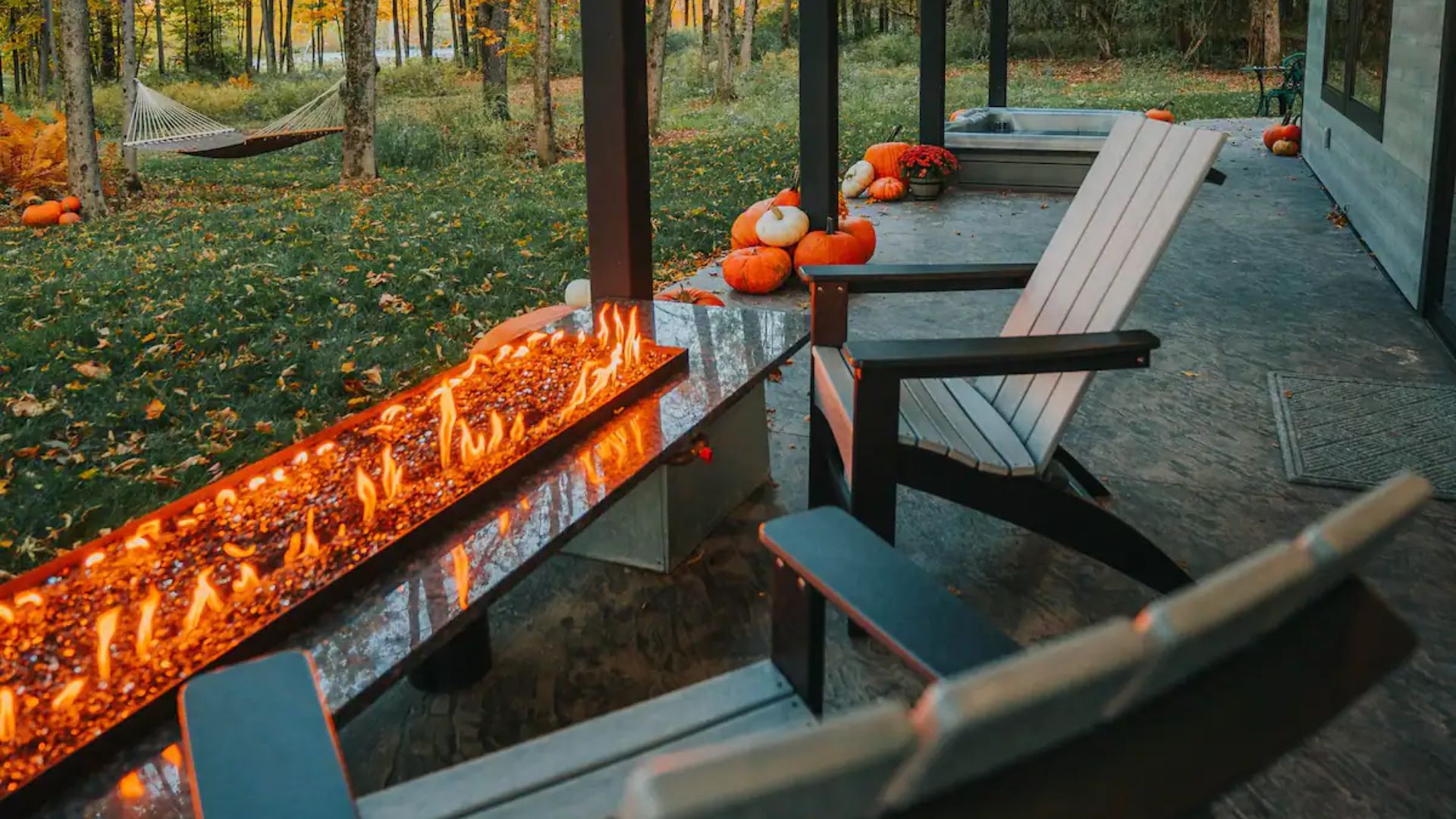 two chairs and a fire pit on a patio of the hickory outpost house