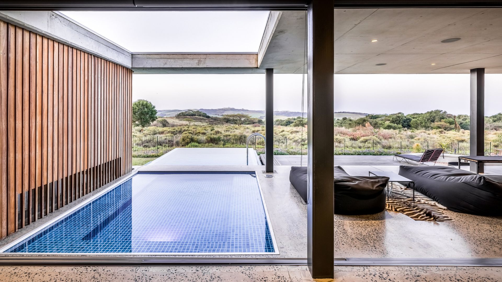 pool that goes inside the lounge area and outside into the garden