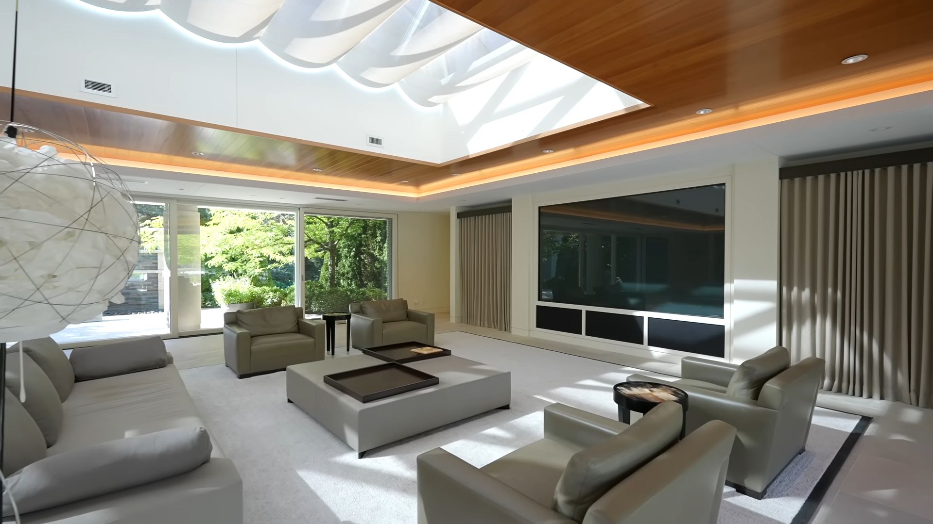 pool pavilion living room with a massive 110-inch TV and lots of sitting places