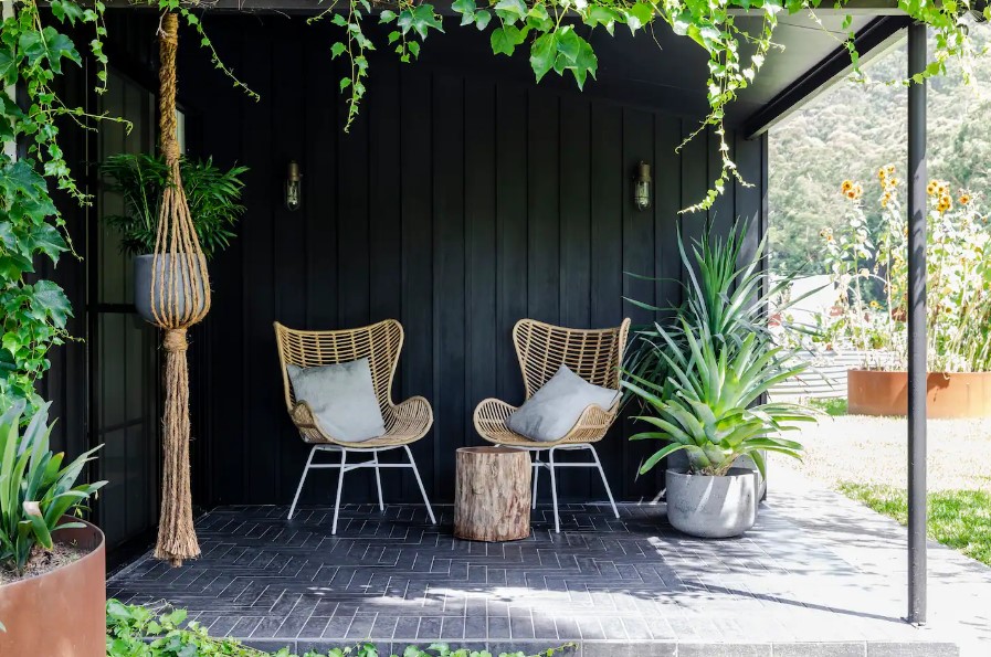 porch with two chairs and a lot of plants