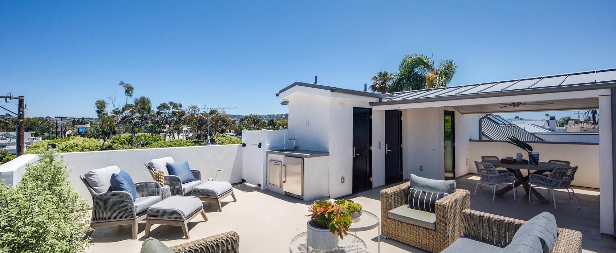 roof terrace with tables and chairs and a fridge