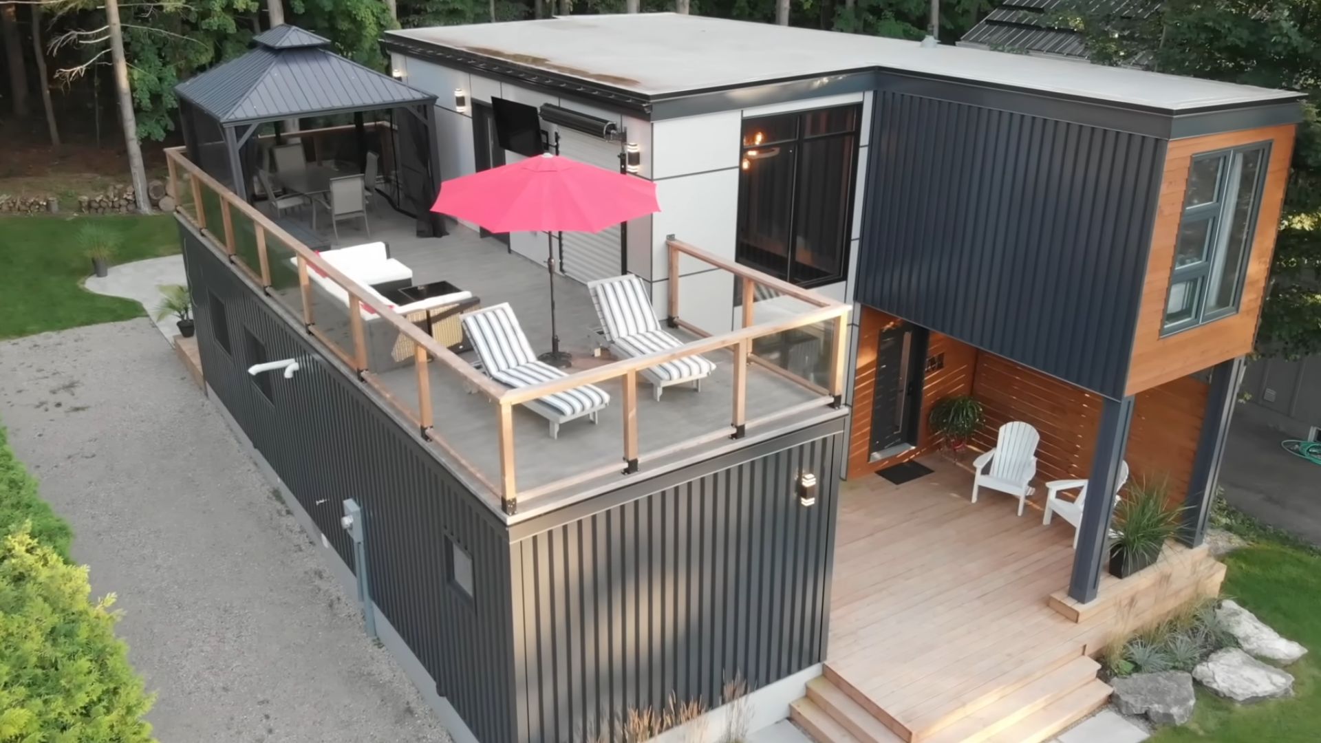 container home with a rooftop deck and comfy lounges with a pink sunshade