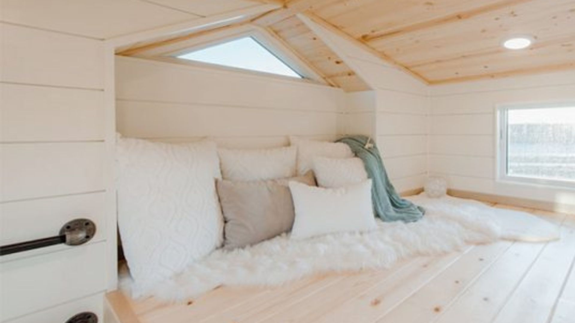 empty second loft with lots of cushions, pipe ladder to climb it, and a window with lots of light