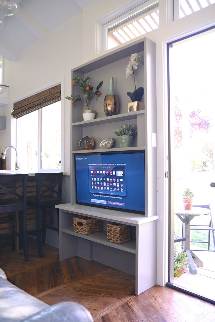 gray shelf with decor and a flat screen tv