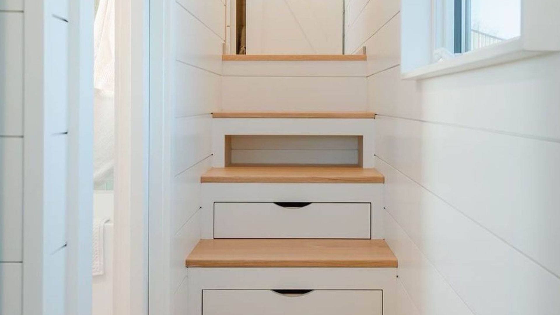 stairs that lead to the bedroom loft with built-in drawers for extra storage