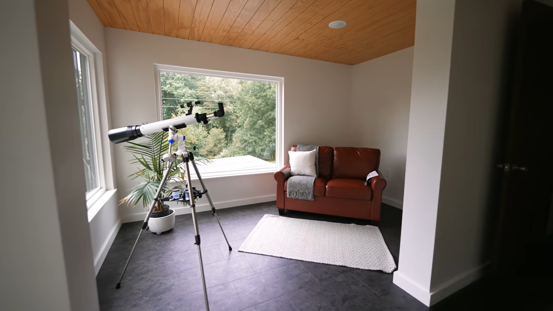 telescope and a small, brown couch