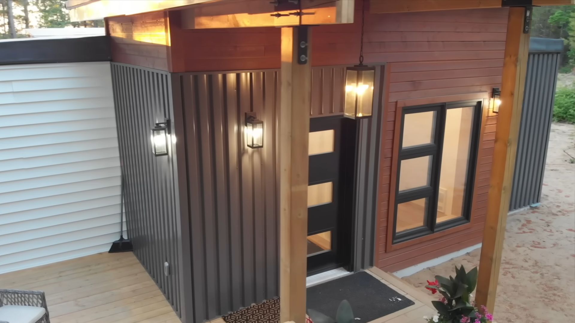 corrugated metal, maibec wood panels, and vinyl used for exterior of the container home