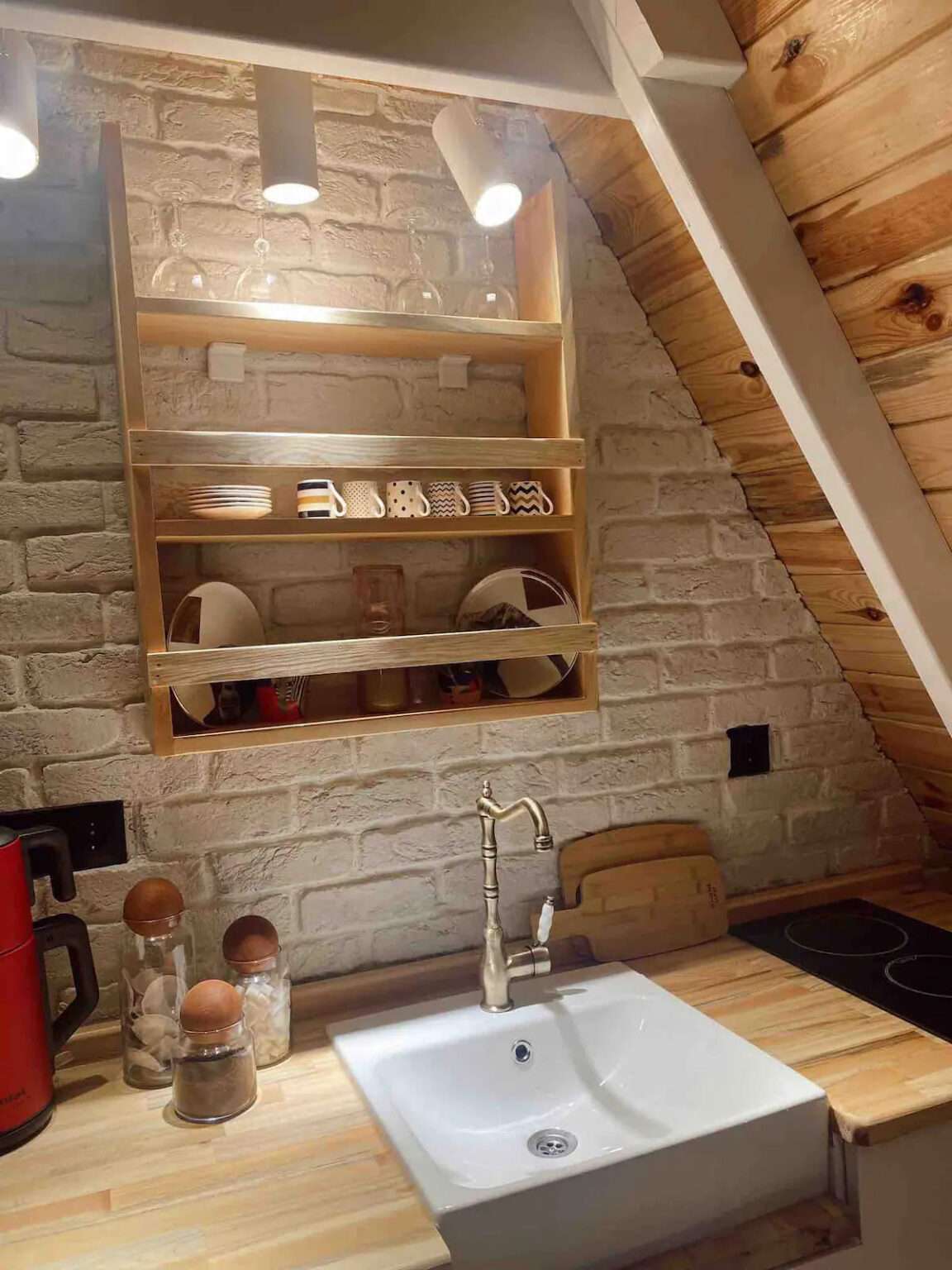 tiny kitchen with an open shelf with dishes