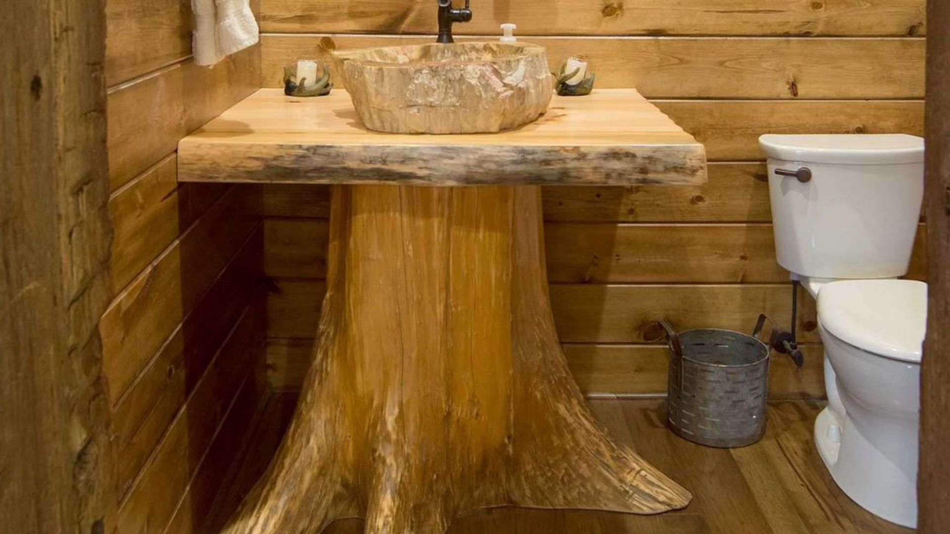 unusual tree stump bathroom sink with a white toilet bowl