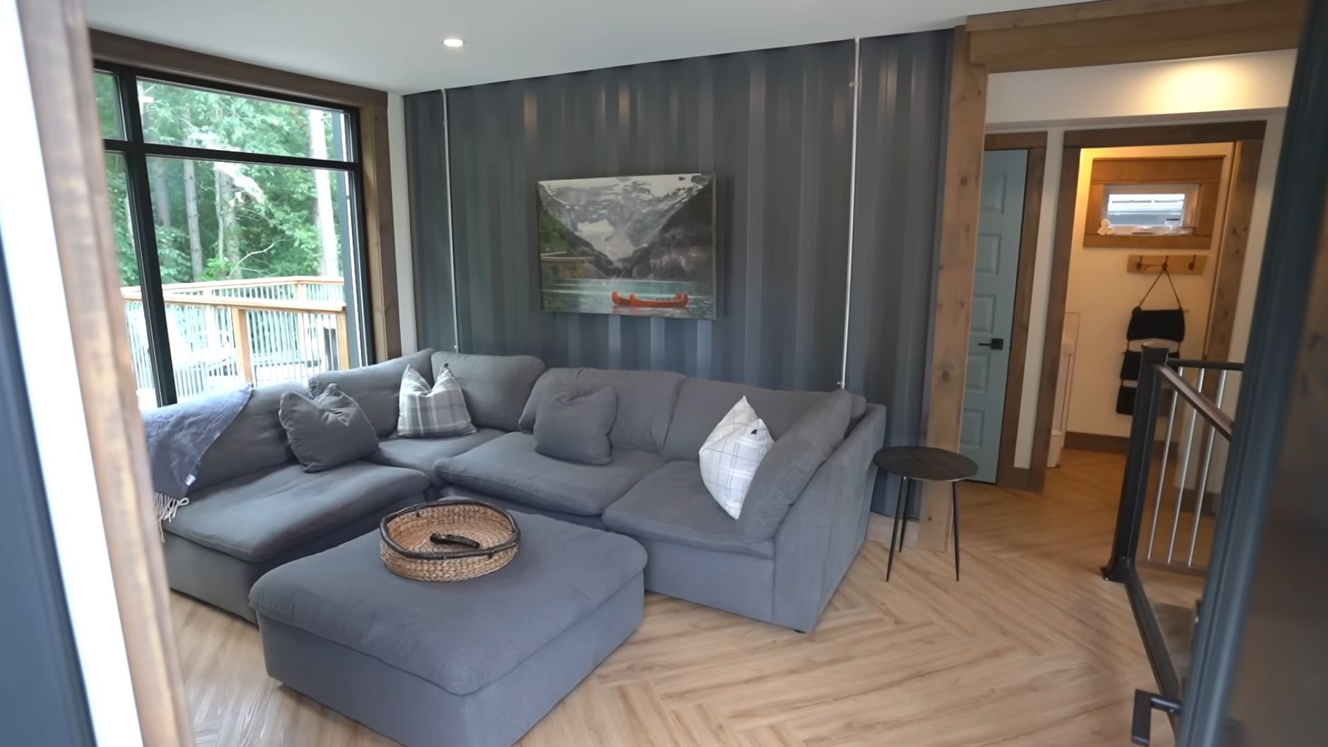 upstairs living room with anthracite sofa and corrugated steel wall