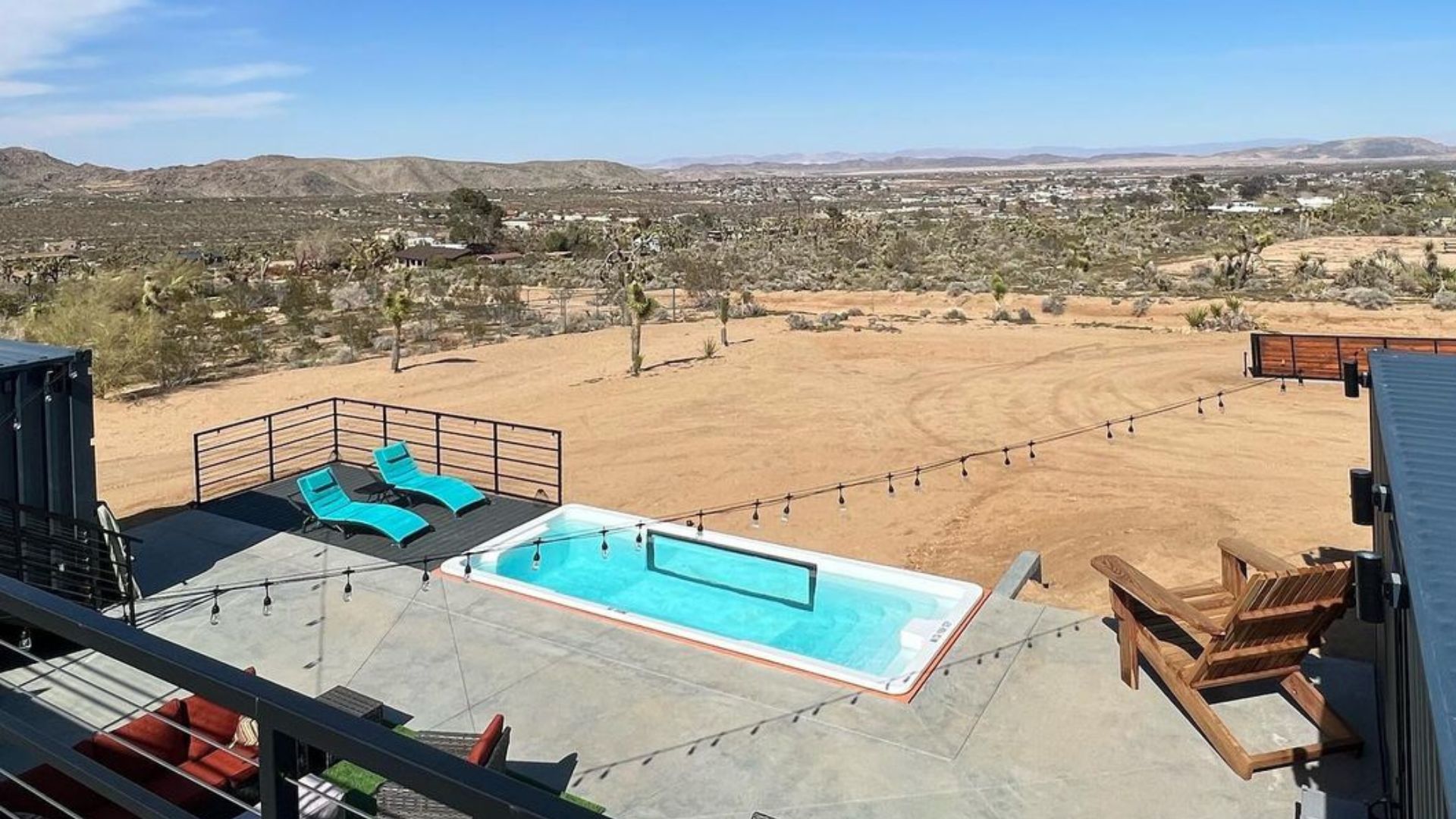 desert view from the rooftop deck with a swimming pool in the photo and patio