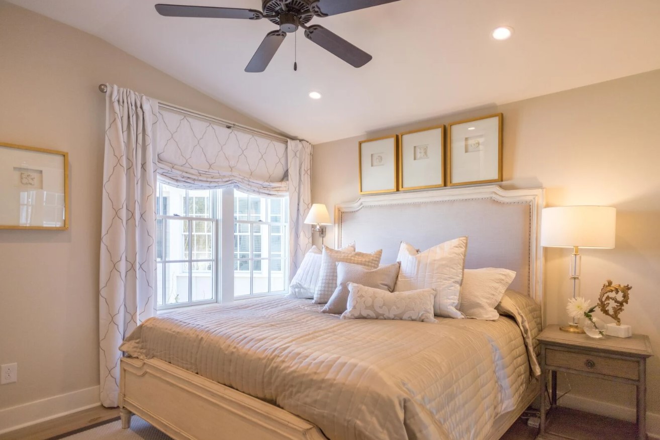 bedroom with a big bed, bug bed frame and white curtains