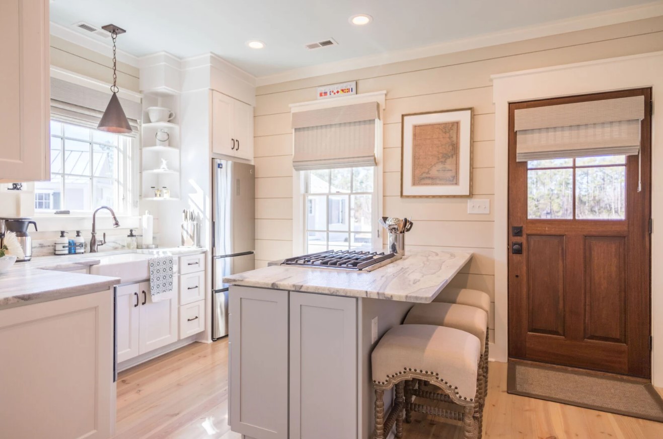 kitchen with white cabinets and white shelves and a marble countertop