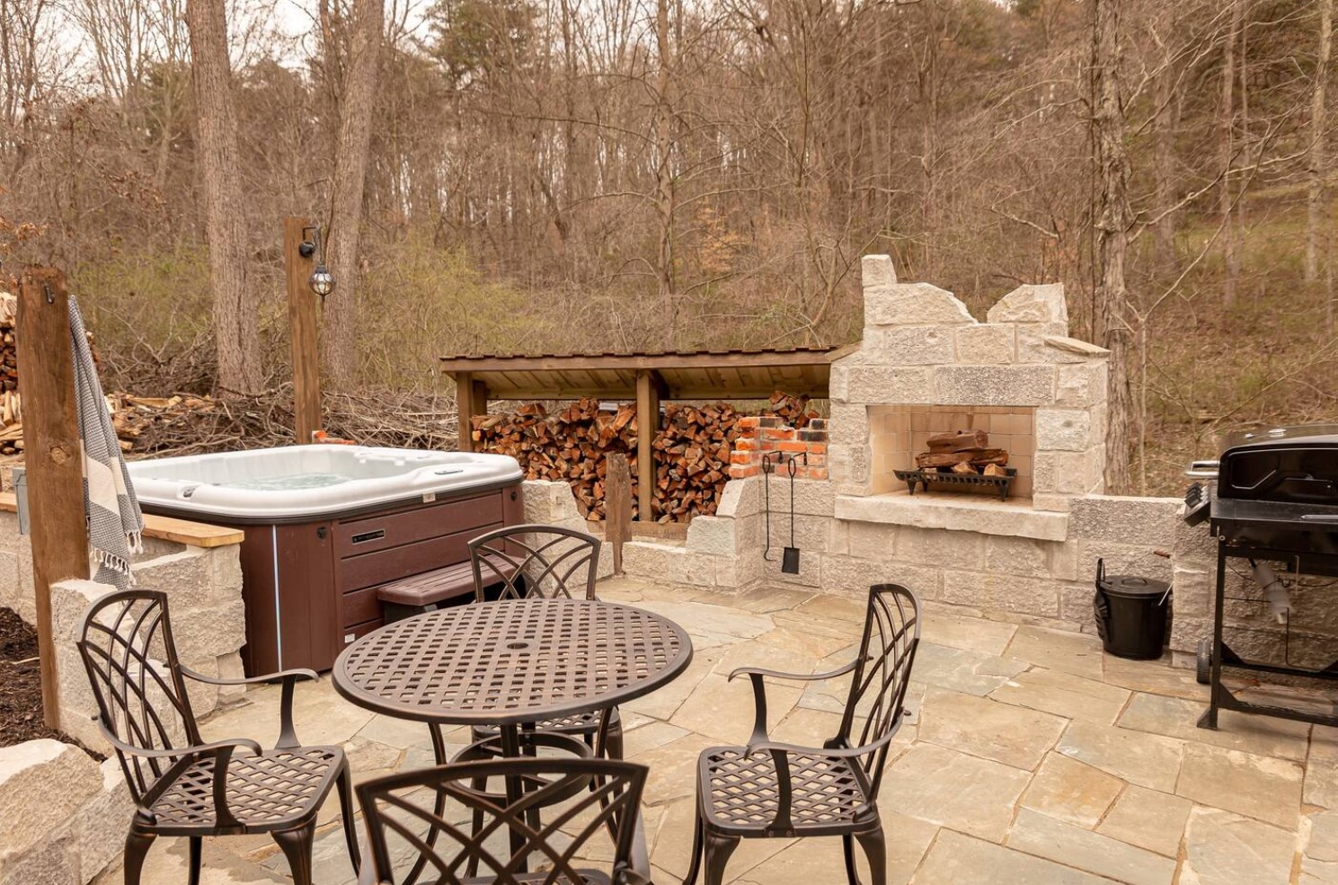 Backyard with fireplace and hot tub