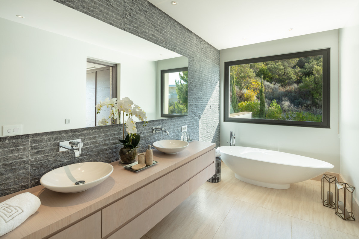 Master bathroom with freestanding tub and a picture window