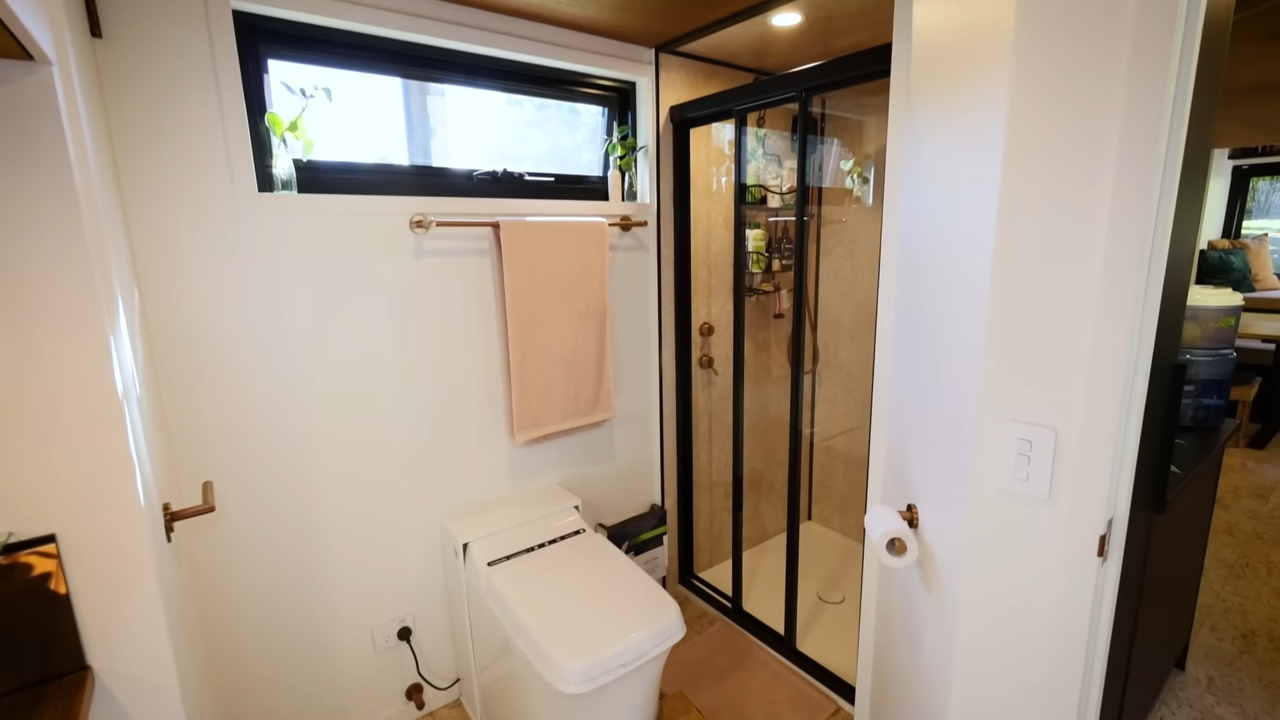 Bathroom with a wooden walk-in shower and a big window