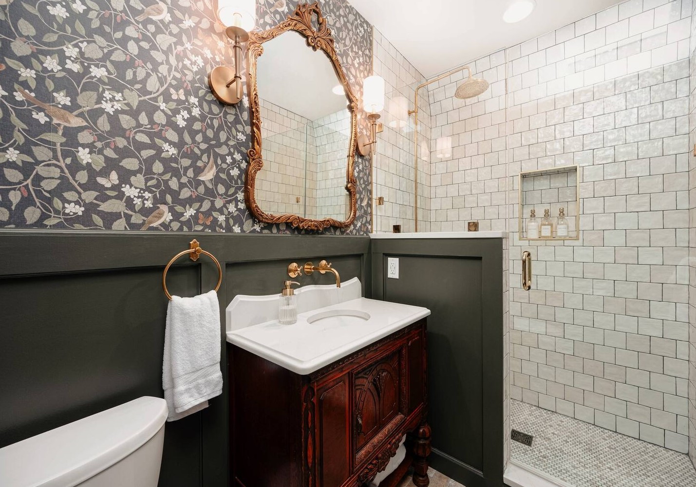 Bathroom with wallpaper and golden mirror