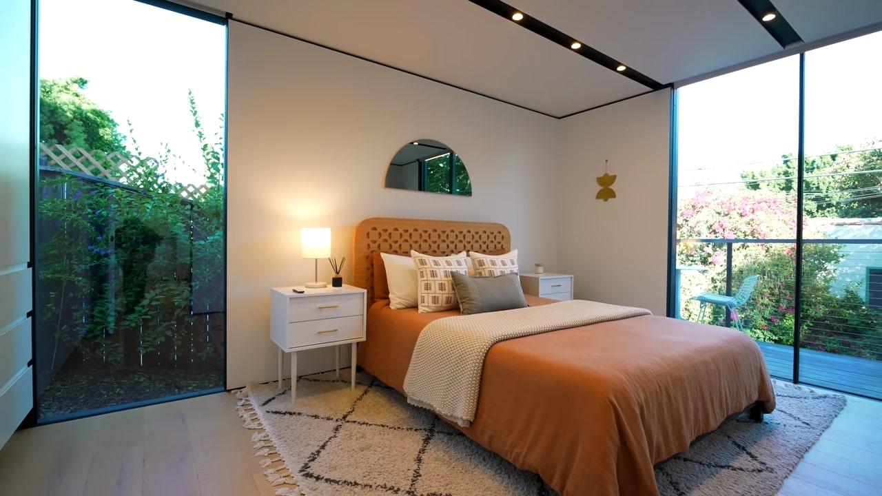 Bedroom with orange bed and huge windows