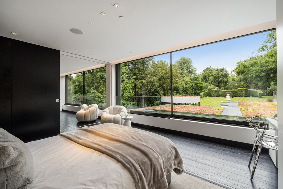 Bedroom with huge glass portals overlooking the garden