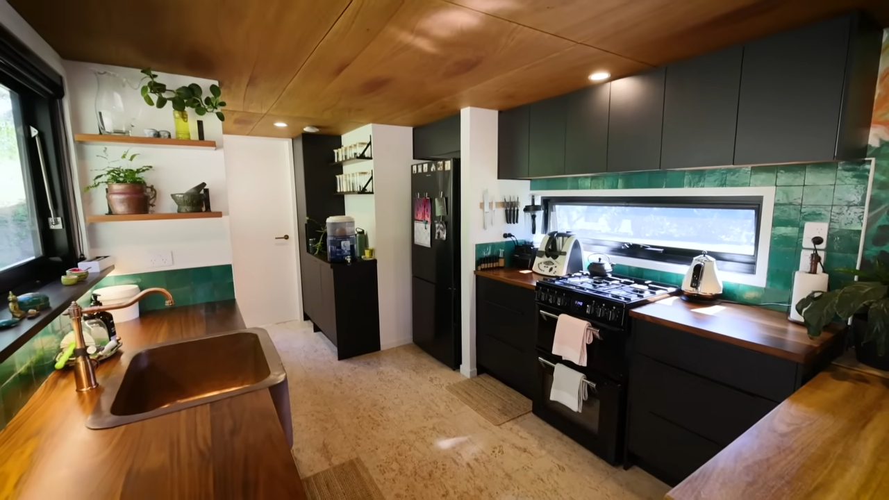 Big kitchen with full-sized appliances and black cabinetry