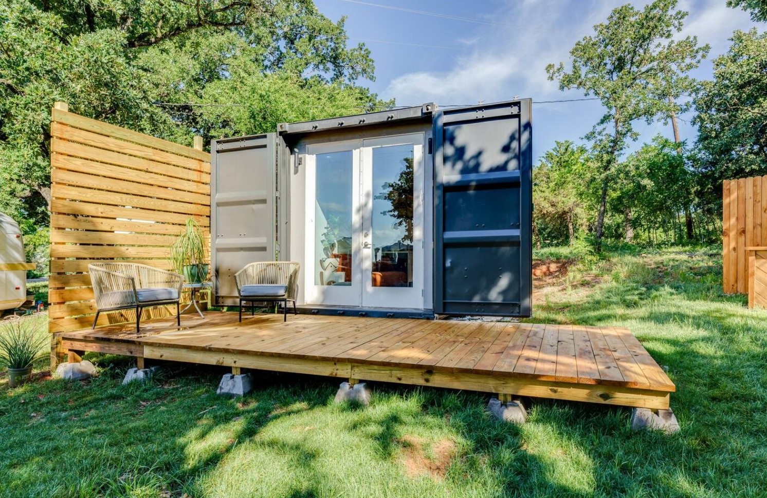 Container home with a porch and two chairs