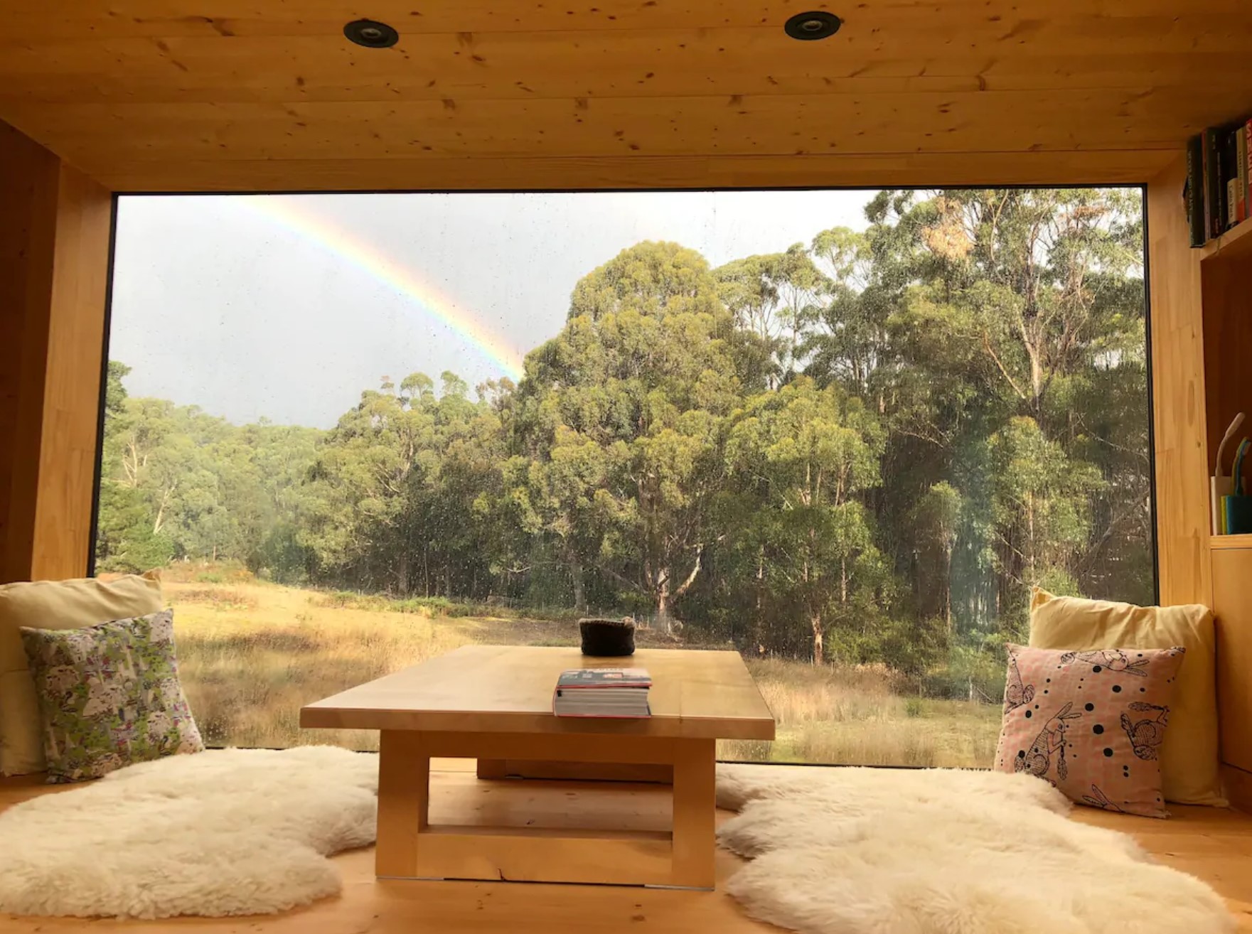 Wooden daybed with a little table and comfortable cushions