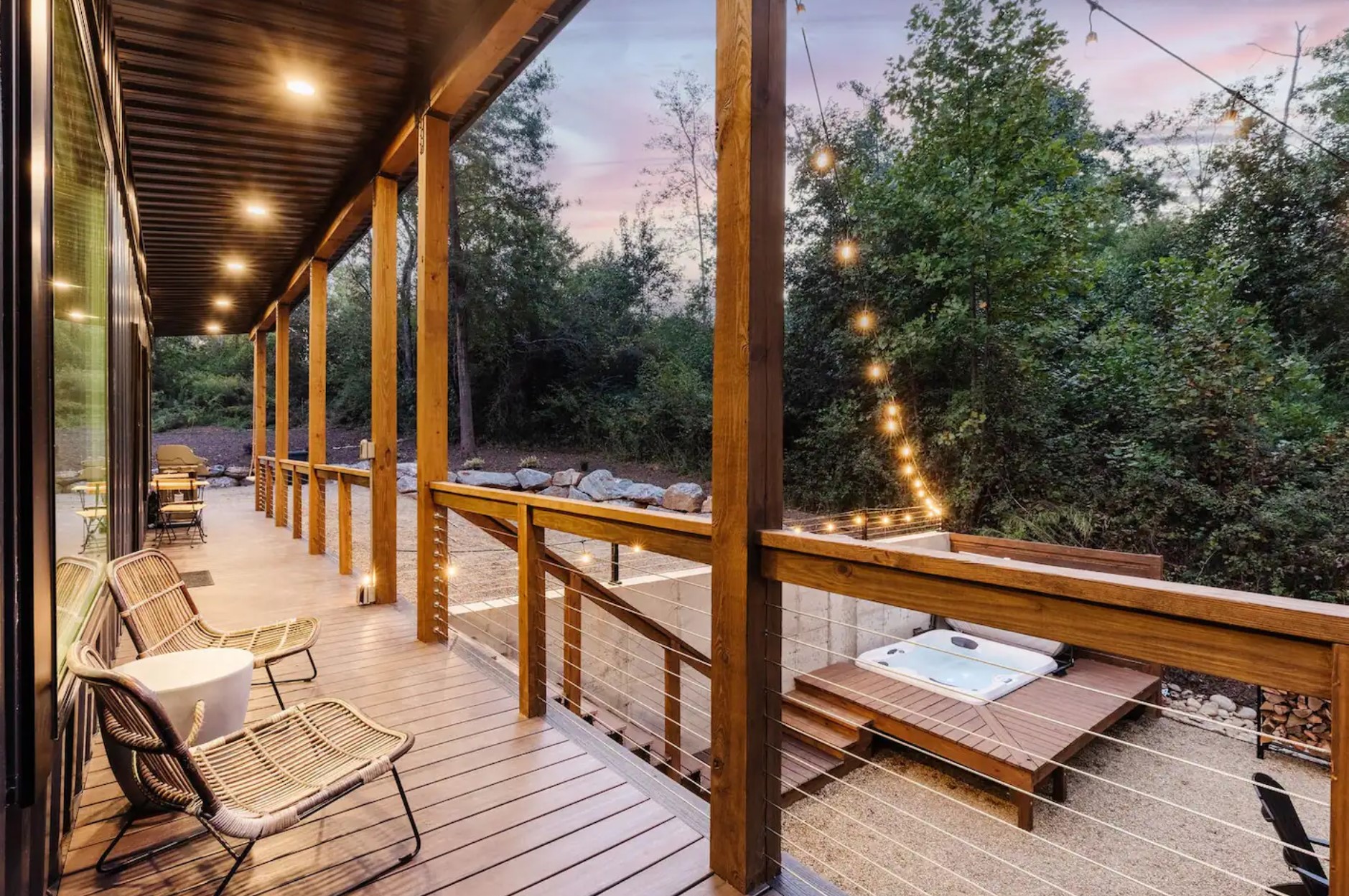 Wooden deck area with grill and hot tub