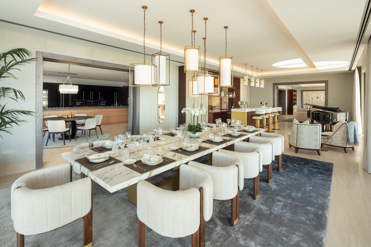 Dinning room with huge marble table and withe light fixtures above it