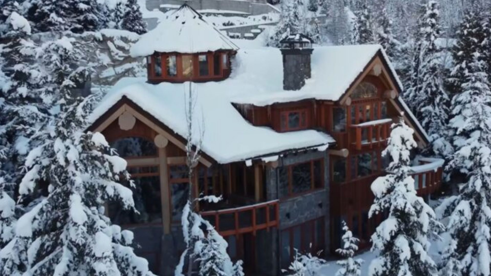 exterior of a cabin covered in snow