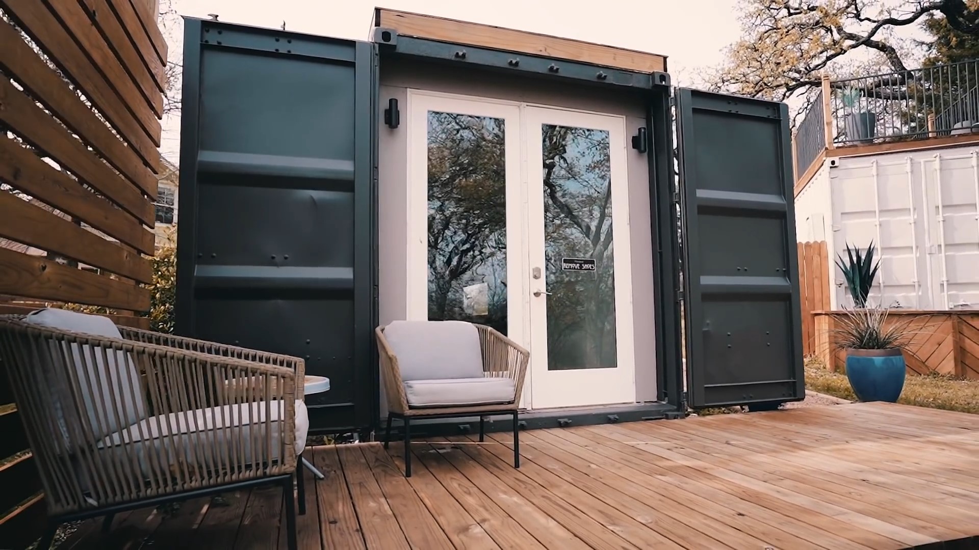 Entrance to container home with a big white door