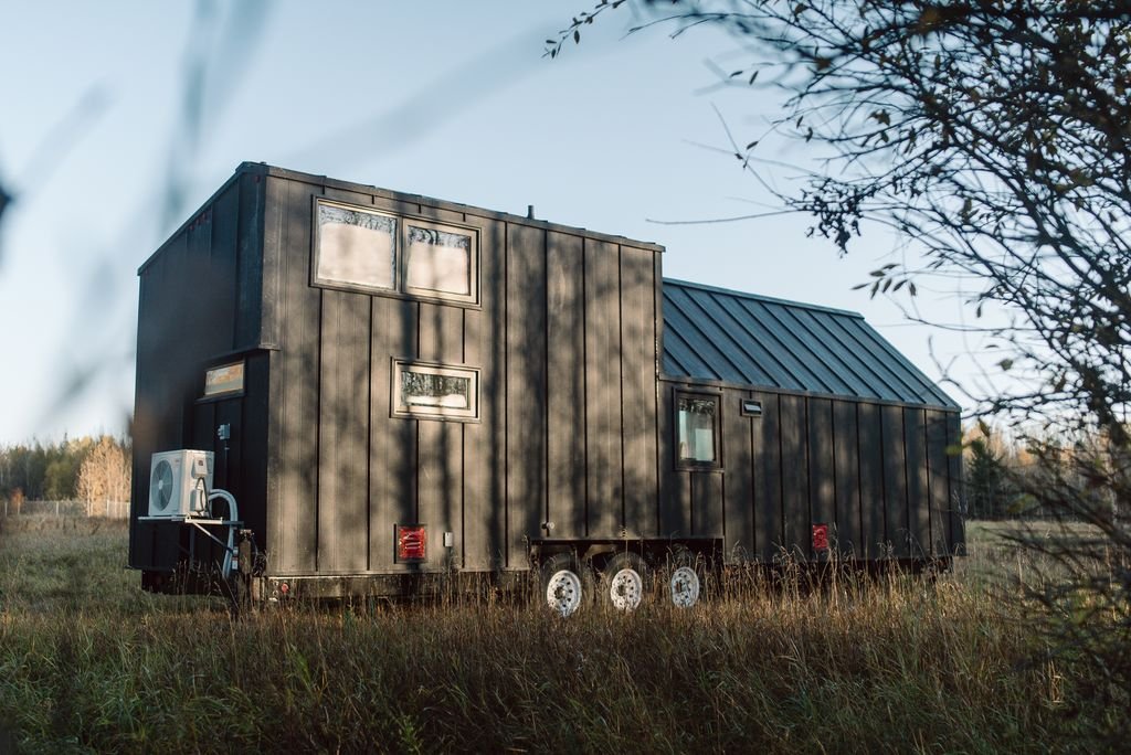 Exterior of black tinny house on wheels