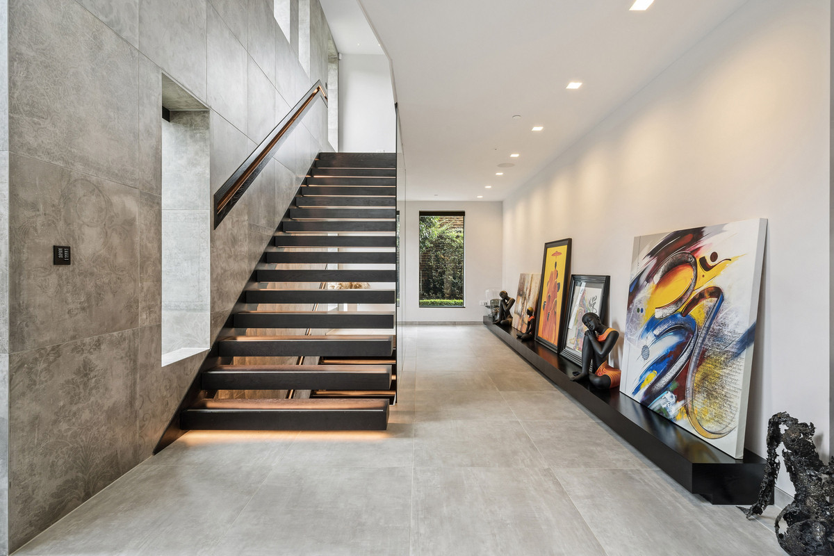 Minimalistic hallway with art and floating stairs