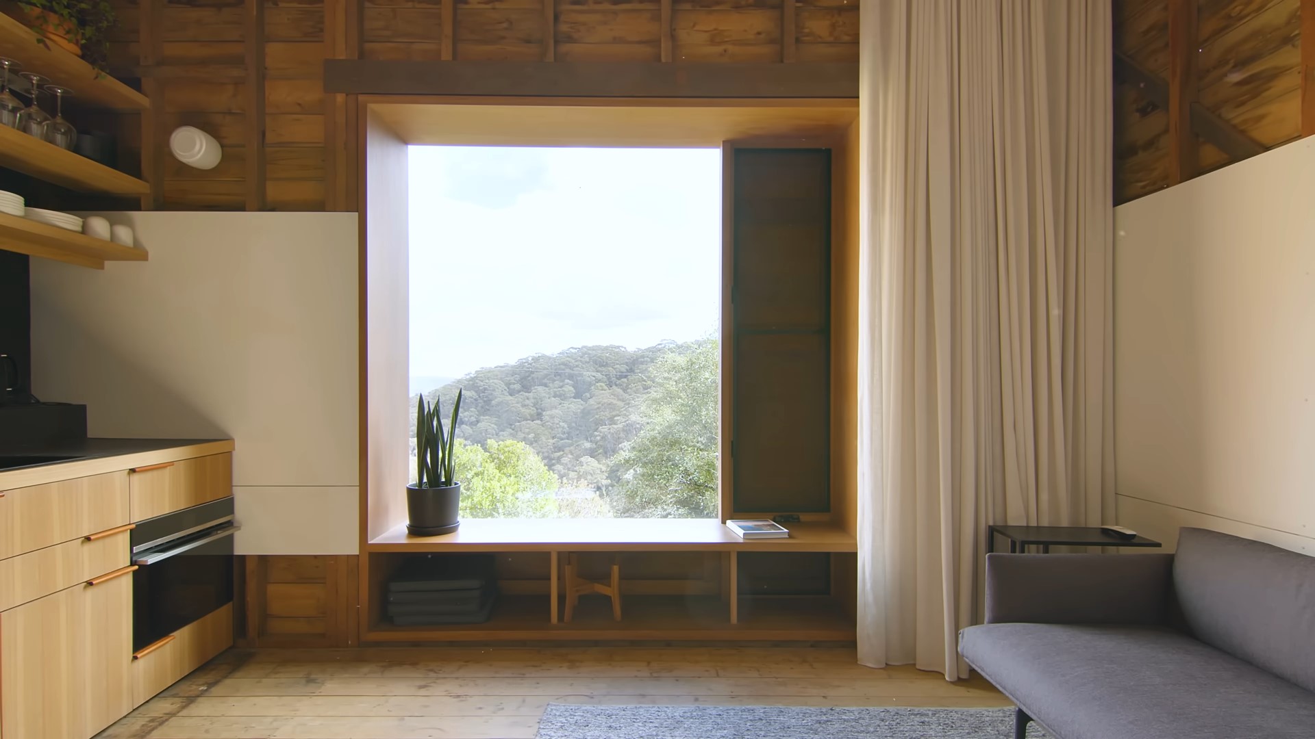 Large window in main living space with a bench