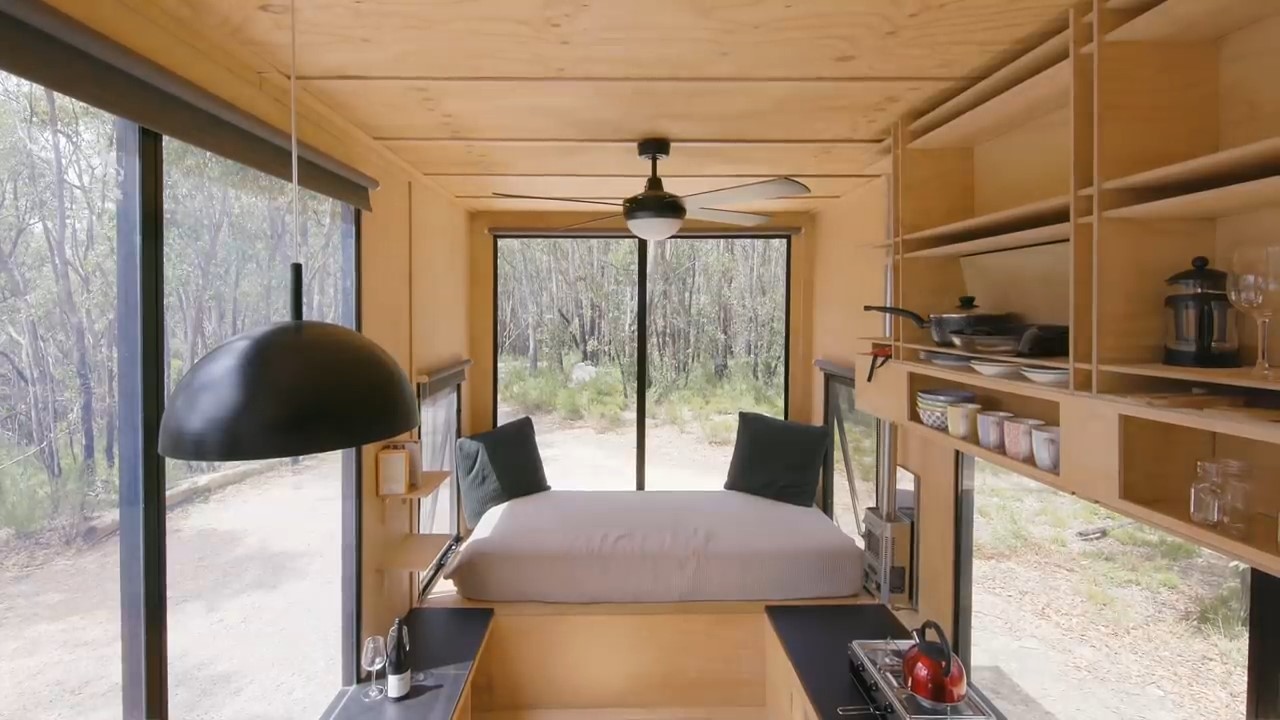 Large window with comfortable bench and pillows in tiny home