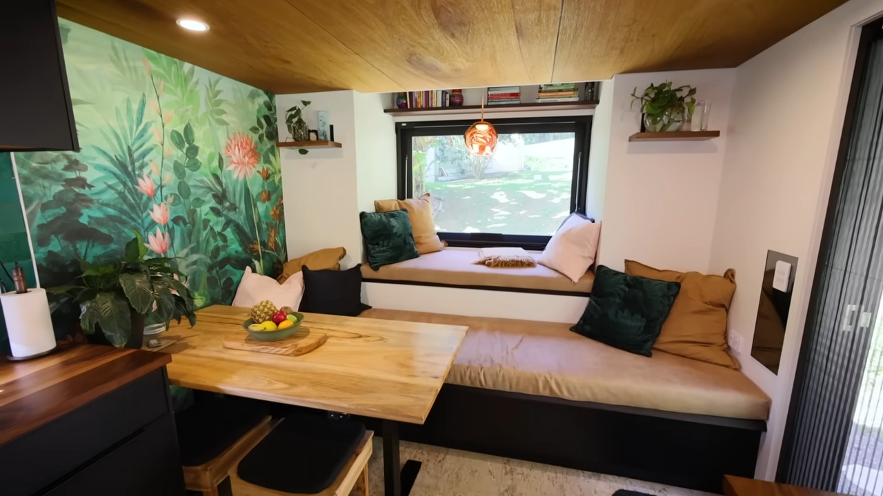 living room with two wooden benches and a picture frame window