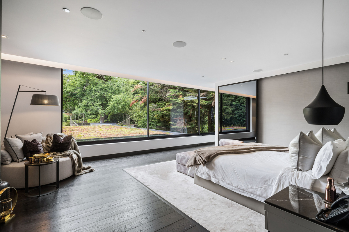 Master bedroom with a king-sized bed and a glass portal