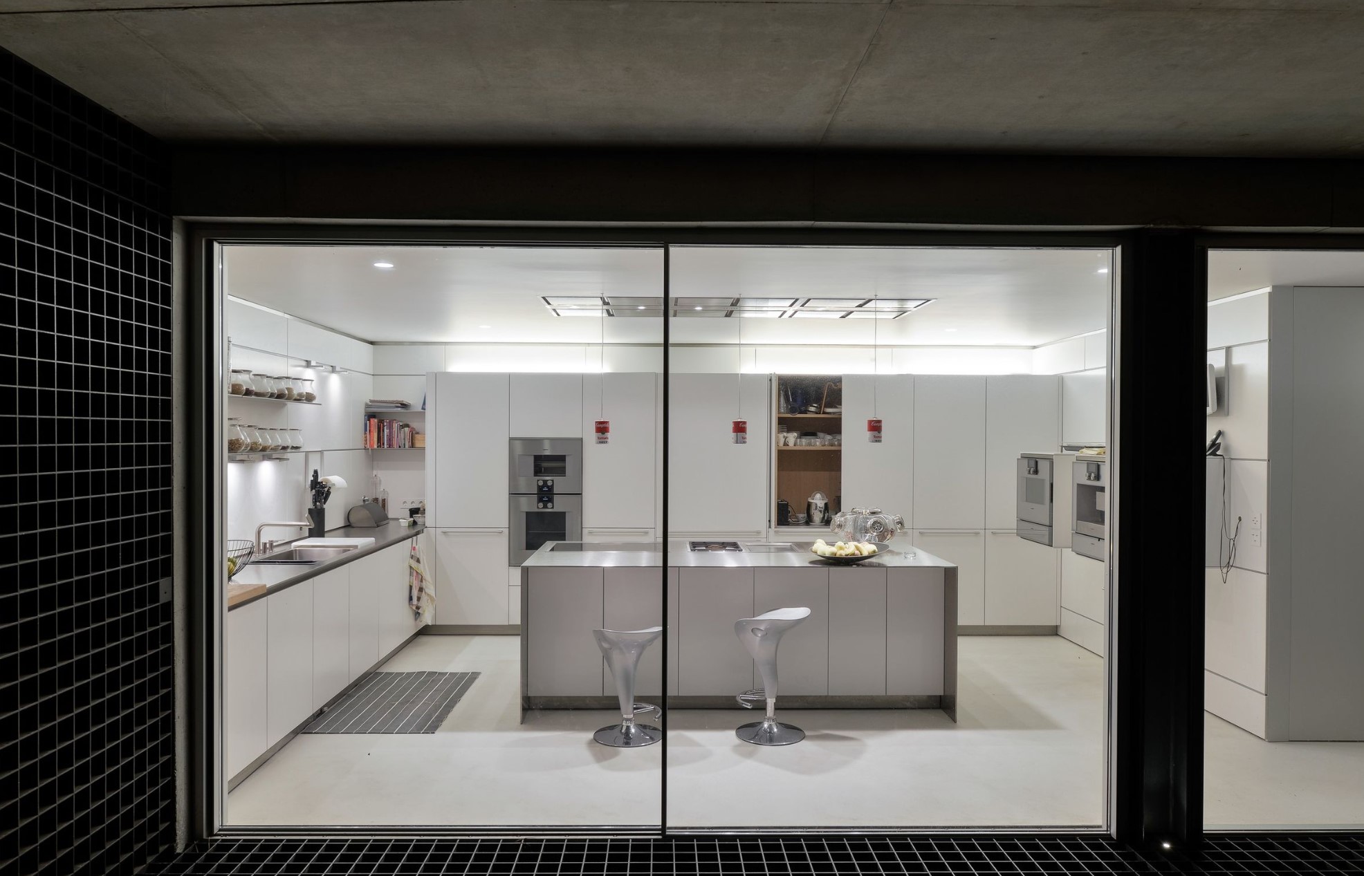 Minimalistic white kitchen with stainless steel details