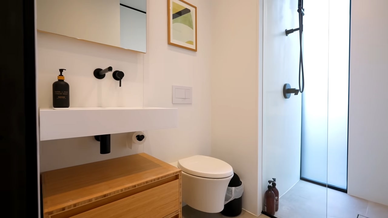 Sleek minimalistic bathroom with bamboo vanity and walk-in shower